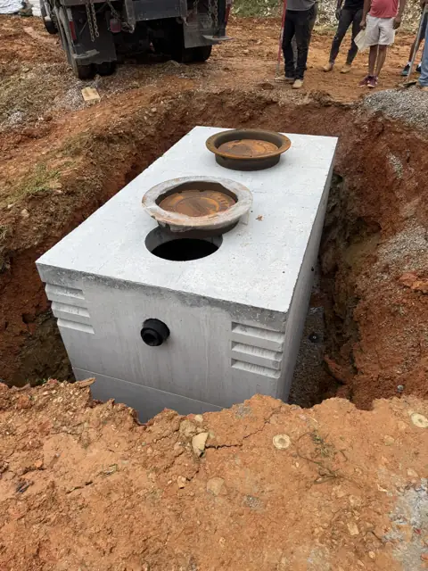 Concrete septic tank set in the excavation