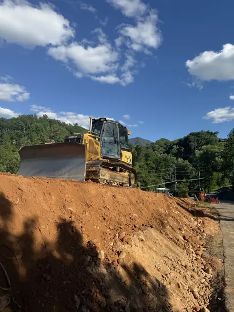 Dozer working a pile of red clay