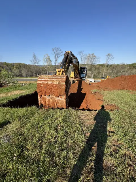 Excavator and bucket working a field