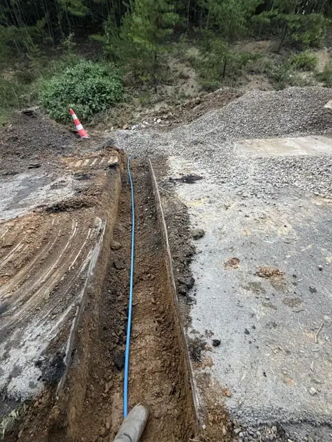 Utility line laid in an open trench