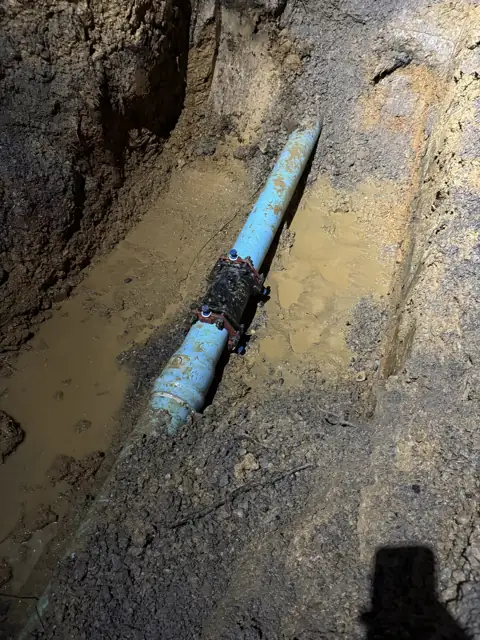 Water line exposed in an open excavation