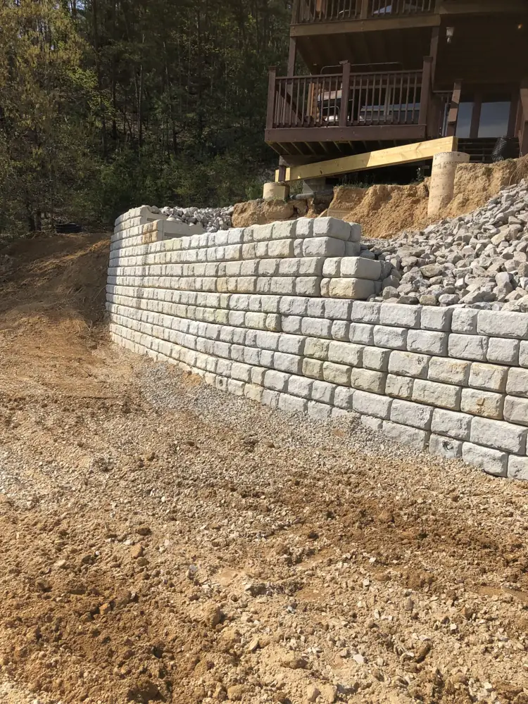Block retaining wall holding back a hillside