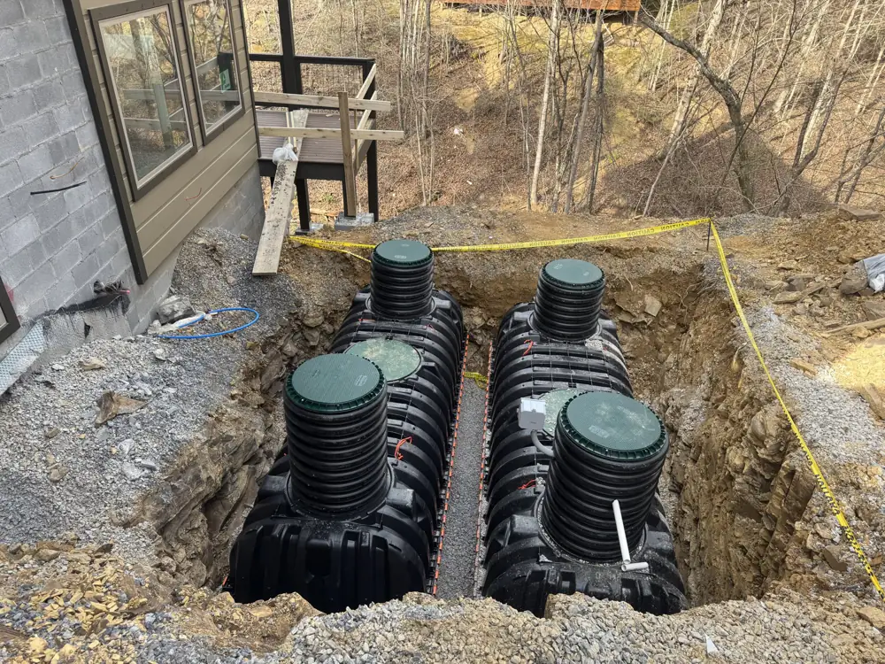 Plastic septic tanks set in an excavation beside a home