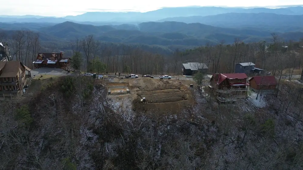 Aerial view of a hillside build site with cabins in Sevier County, TN